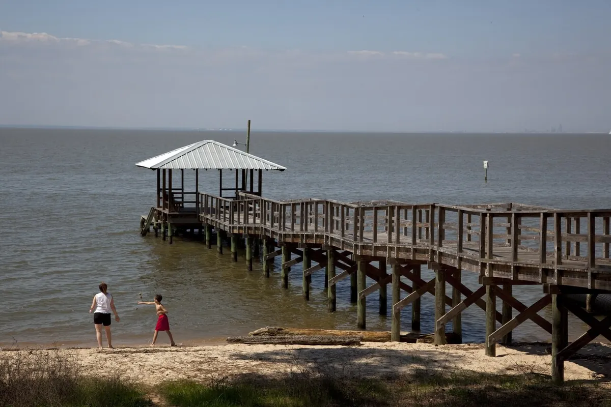 The municipal pier on Mobile Bay at Fairhope AL, with the Mobile skyline faint across the water