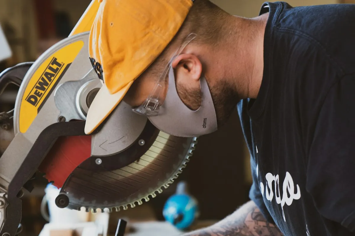 A carpenter marking a board at a mitre saw during a cabinet installation in Mobile AL